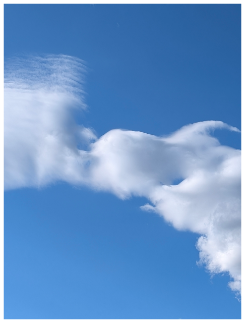 an interesting formation of clouds in a blue sky.