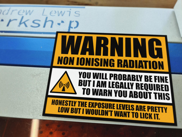 A metal sign warning of non ionising radiation. It's probably fine, but don't lick it. 
