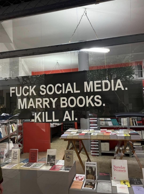 Large sign in a book store window that reads “fuck social media. Marry books. Kill AI.”