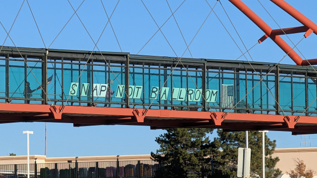 Sign on a pedestrian overpass over US 36 reads "SNAP NOT BALLROOM" 