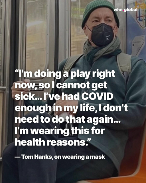 Photo of Tom Hanks sitting on public transit wearing a dark beanie, scarf, backpack, and a black respirator mask; the whn.global logo appears at top right. Overlaid quote in large white text reads:
“I’m doing a play right now, so I cannot get sick… I’ve had COVID enough in my life, I don’t need to do that again… I’m wearing this for health reasons.”
— Tom Hanks, on wearing a mask.