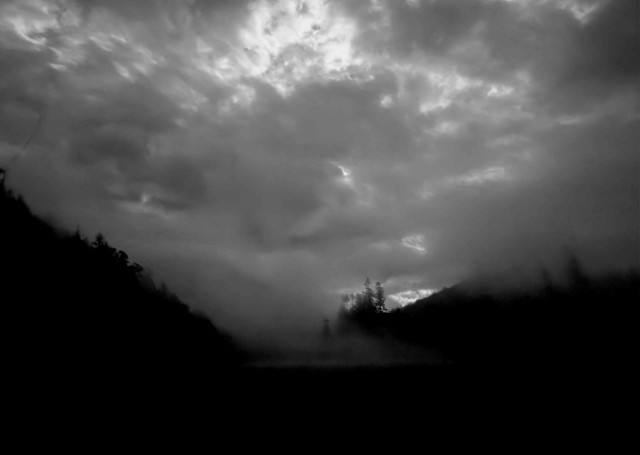 mist rising from a field into a night sky of low cloud