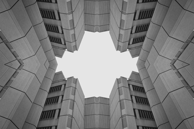 An. abstract black and white symmetrical architecture photo of a brutalist building.