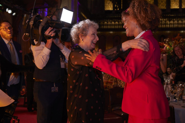Margaret Atwood and Bernardine Evaristo congratulate each other on jointly winning the prize in 2019. Atwood is a white woman with white hair, and Evaristo is a Black woman with natural hair.
