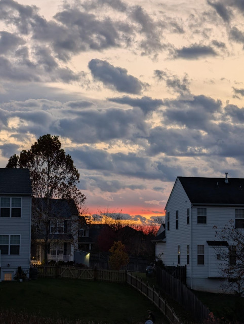 Bright orange sunset between the houses