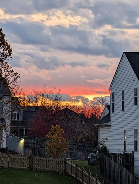 Bright orange sunset between the houses