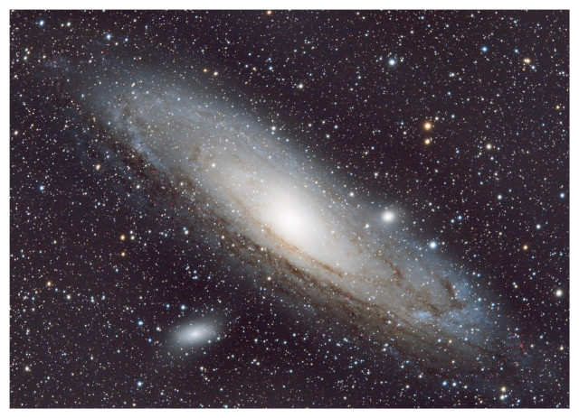 Image of the Andromeda Galaxy (Messier 31/M31), our closest neighboring galaxy at 2.5 million light years away. It appears here tilted diagonally from upper left to lower right, in a vast field dense with stars of different colors. Near the galactic core are two noticeably bright spots: M110 to the lower left and M32 to the right, two of the 35 dwarf galaxies orbiting Andromeda.

Data taken from the Amateur Astronomers Association’s Gateway Remote Telescope program. Processed by me in Siril, GIMP, and Snapseed.