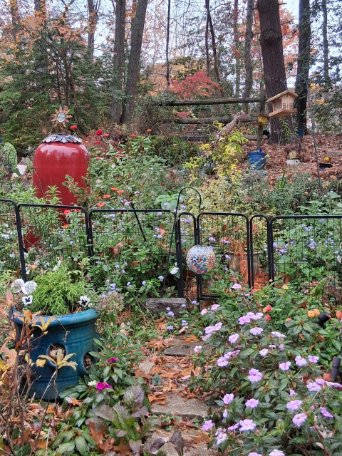 Colorful fall garden with s red urn fountain
