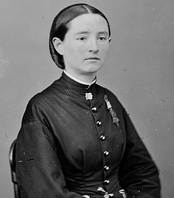 Dr Mary Edwards Walker in a dress in around 1863, wearing the medal. She is a white woman with dark hair tied back.

