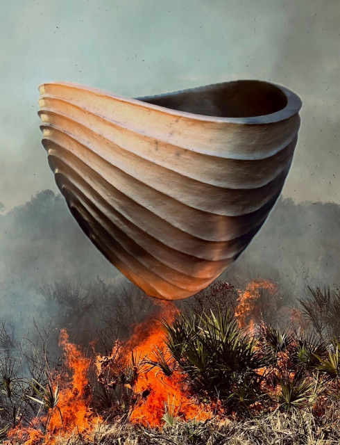 One of my smoke fired pots collaged on top of a photo of a prescribed or controlled burn in Sarasota County. The pot is a gradient of tones from terracotta to grayish black. It has a wide mouth and narrow foot—a very deep bowl. The lip is curved and a series of ridges follows the curve of the rim all the way down to the foot. The background shows a brush fire with gray smoke filing the air above.  