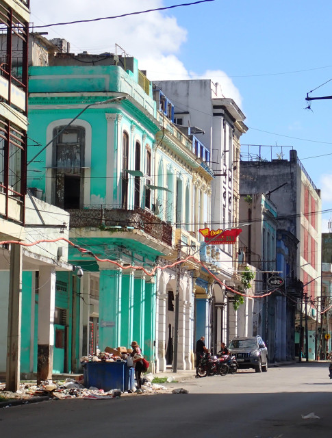 A man digging through thrash in over-full containers in the streets of Centro Habana. During my visit this time I saw much more people going through thrash than last time (seven years ago).