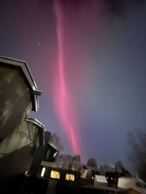 red aurora over head in clear dark sky