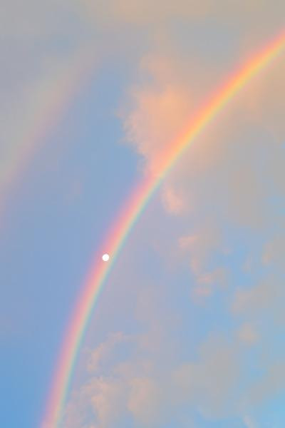  The moon perfectly framed by a rainbow. 