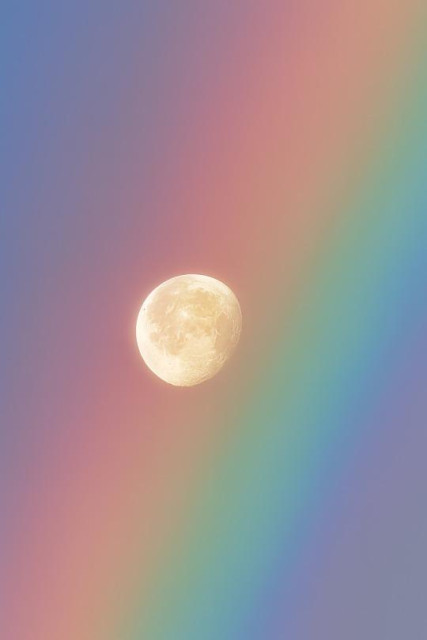 The moon perfectly framed by a rainbow even closer.