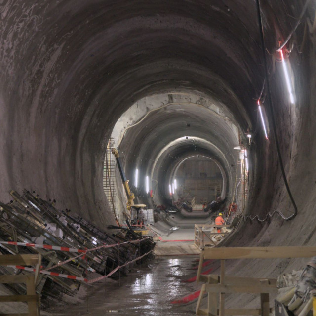 view into a tunnel construction site. the tunnel has an oval cross section and spray concrete walls