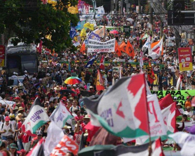 Enormous crowds with flags and banners marching through Belem