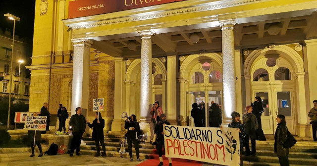 A group of protesters with banners and placards outside the theatre in Rijeka