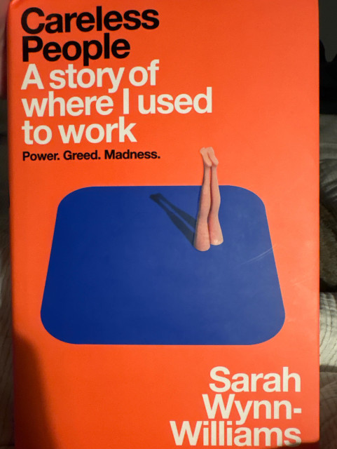 Book cover, orange with a blue square the save shape and colour as the Facebook logo background with a pair of women’s legs disappearing as if into a portal.