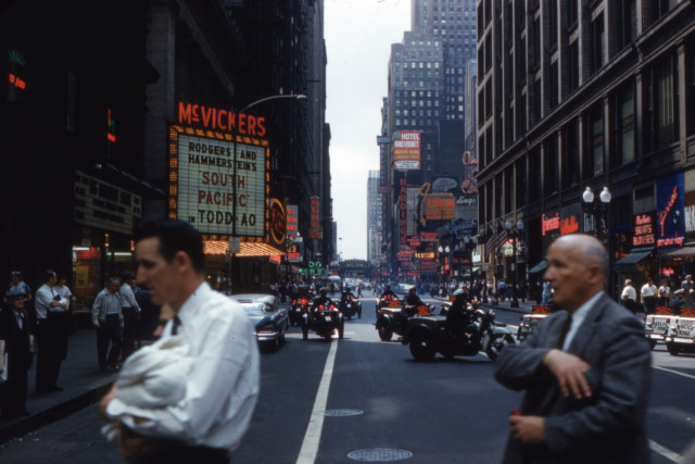A photo of a Chicago city street in 1958, taken in front of McVickers theatre.