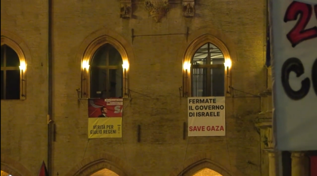 Two banners hanging from windows: END THE ISRAELI GOVERNMENT, SAVE GAZA
