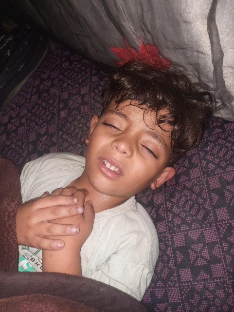 My four-and-a-half-year-old son, Ibrahim, is lying in bed with a fever. He is in pain all night.