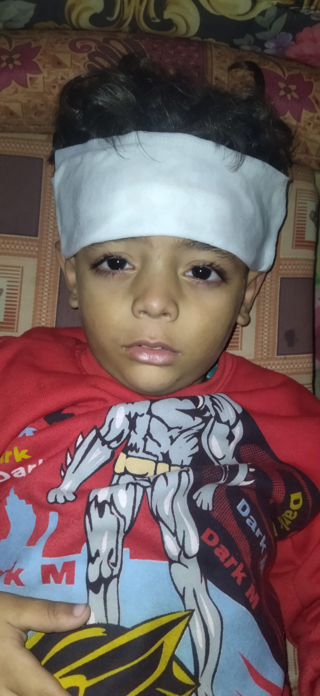 My four-and-a-half-year-old son, Ibrahim, is lying in bed with a fever. He is in pain all night and has been putting cold compresses on his forehead.