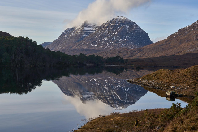 Liathach reflected in Loch Clair. Cloud is gathering and spilling off the tops as if it's on fire. 