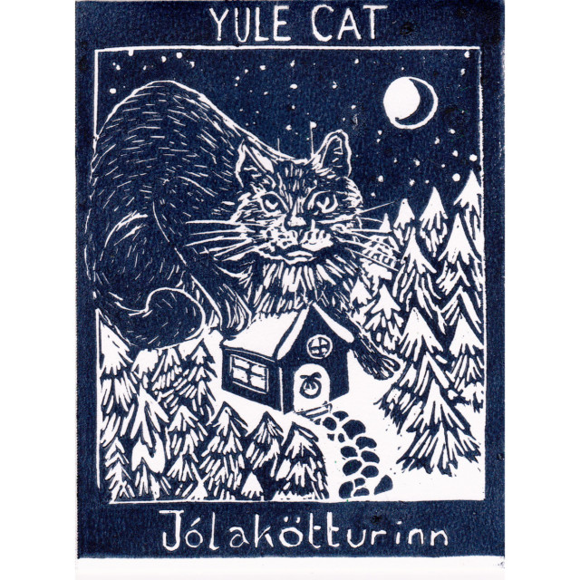 My linocut Yule Cat, a giant cat on a tiny snow covered cabin in a pine forest is printed in dark blue with “Yule Cat” above & “Jólakötturinn” below.