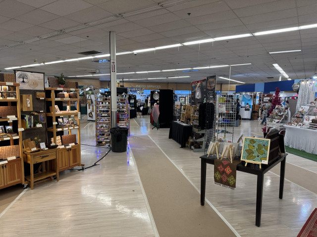 Craft booths at the Allied Arts Festival of the Arts. A booths with a variety of handmade gifts are arranged in the space. 