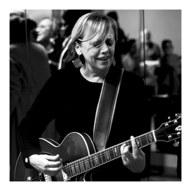Indoor monochrome photography.

Electric guitar player in close-up shot caught in a square framing.
