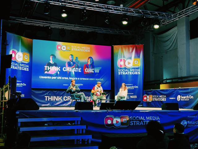 A photo showing the main stage at Tech Week Bologna. In the background: a huge panel saying “think create grow” with the speakers sitting in front. From left to right: Niccolò Venerandi, Morloi and yours truly 