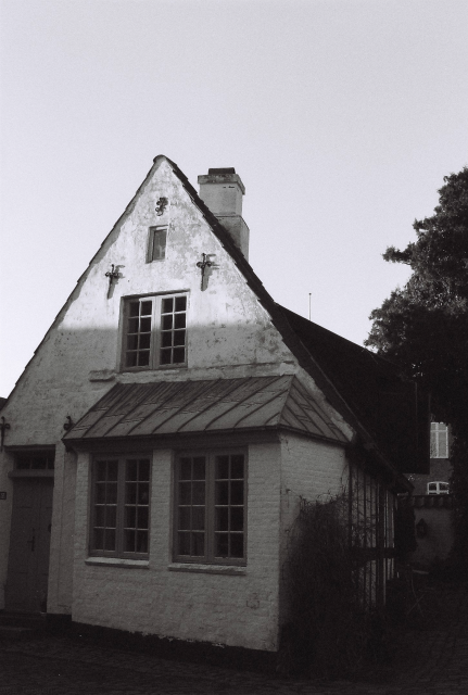 Black and white film photo of a beautiful little old town house in Abenraa