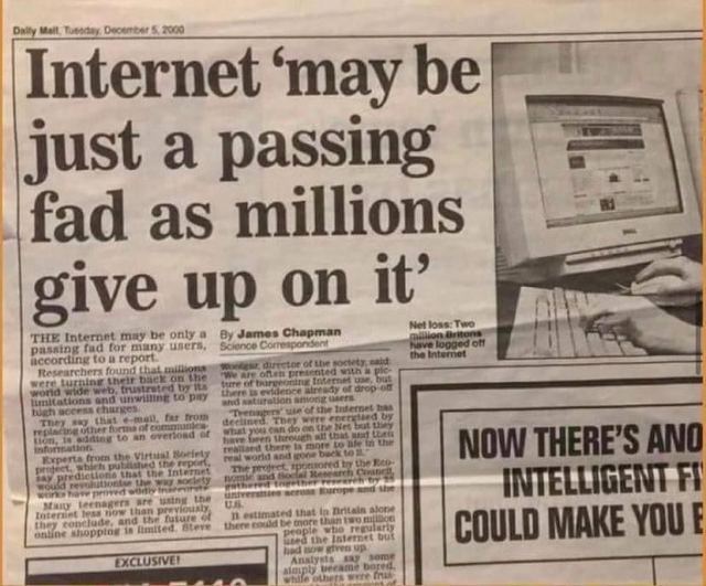 A photograph of a Daily Mail newspaper article from December 5, 2000, with the headline "Internet 'may be just a passing fad as millions give up on it'". The article includes a cropped photo showing hands typing on a keyboard in front of a computer displaying a website.