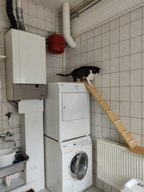 Little ramp going from the top of the dryer halfway to the ground, with a laundry basket next to it for the final jump