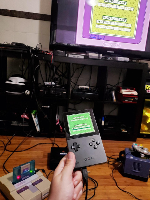 Holding my Analogue Pocket linked to my SNES with the Super Gameboy 2, showing Tetris being played in both