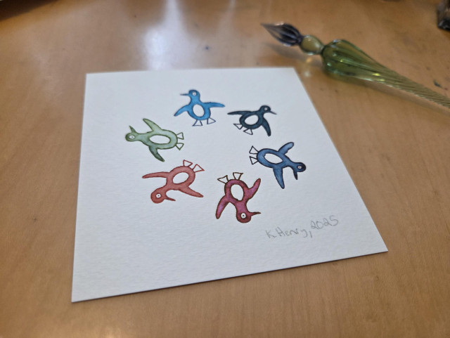 Hand drawn generative/procedural art in ink on watercolor paper. The abstract pattern looks like penguins standing in a circle and facing each other. My glass dipping pen is next to the small drawing.
