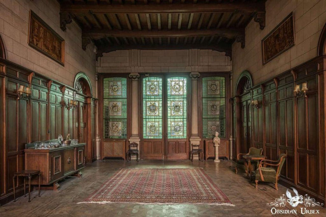 entrance hall with wooden panel walls and stained glass doors 