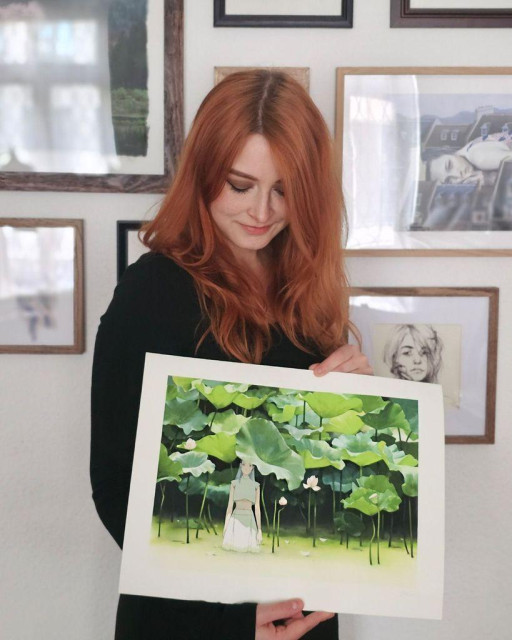 photo of an artist holding an art print