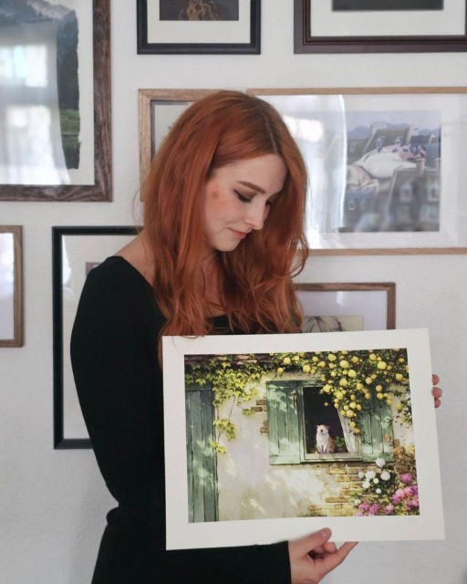 photo of an artist holding an art print