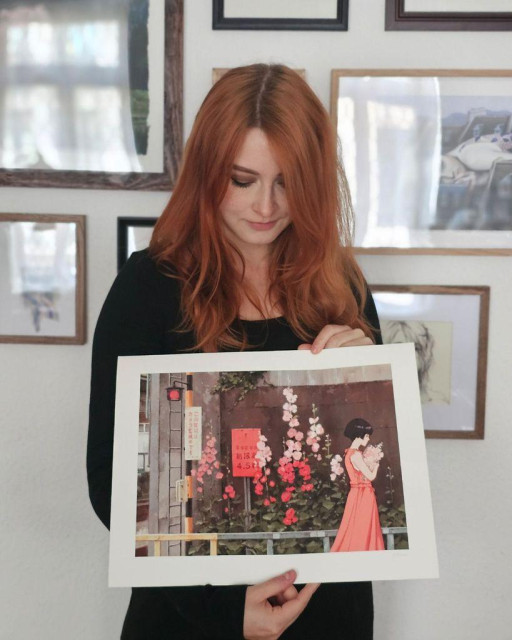 photo of an artist holding an art print
