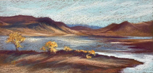 A horizontally long pastel painting of a lake. The mountains in background and the foreground hills are lit by soft afternoon fall sun. Some yellow trees and brushes on the hill. 