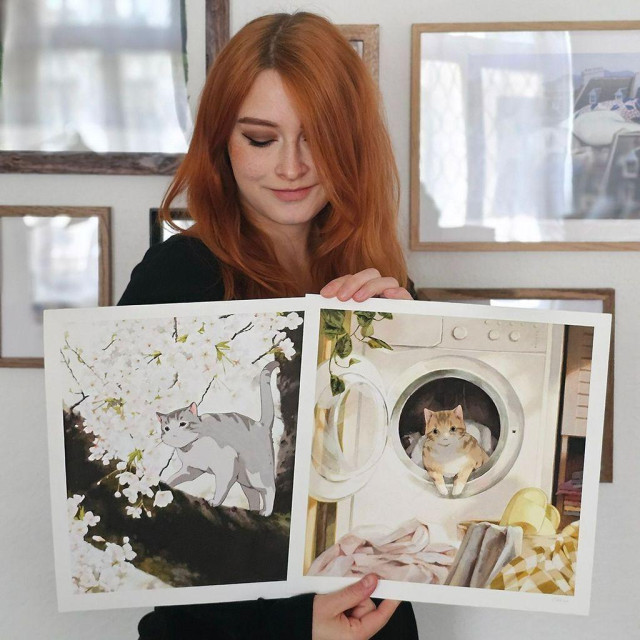 a photo of an artist holding a fine art print