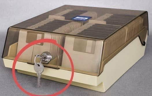 A photograph of a locked transparent case of beige 3.5 inch floppy disks