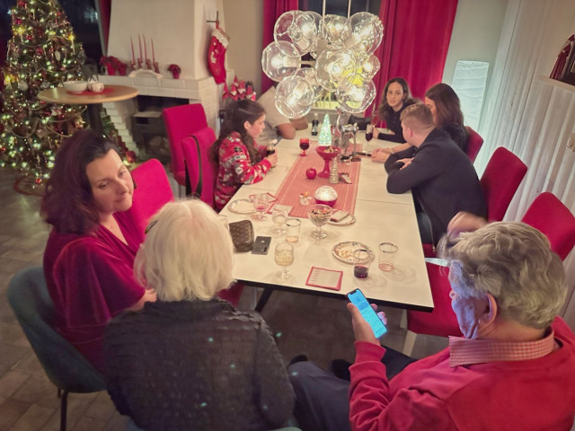 People at a party drinking glögg, a fortified wine drink, somewhat like gluhwine, but good.