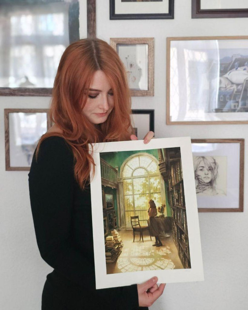 a photo of an artist holding a fine art prints
