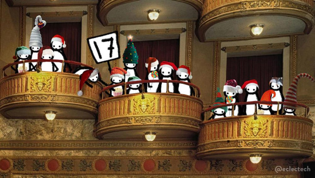 A photo of three boxes in a theatre. They are curved golden balconies, offset to each other, with a red rail above the solid barrier. There are 17 of my Friend folk, all wearing festive hats, sitting or standing in them. One holds a placard with the number 17 on it. Some are eating popcorn, another couple big lollipops. On in the top left box is leaning through the gap to grab some popcorn from the next one down.