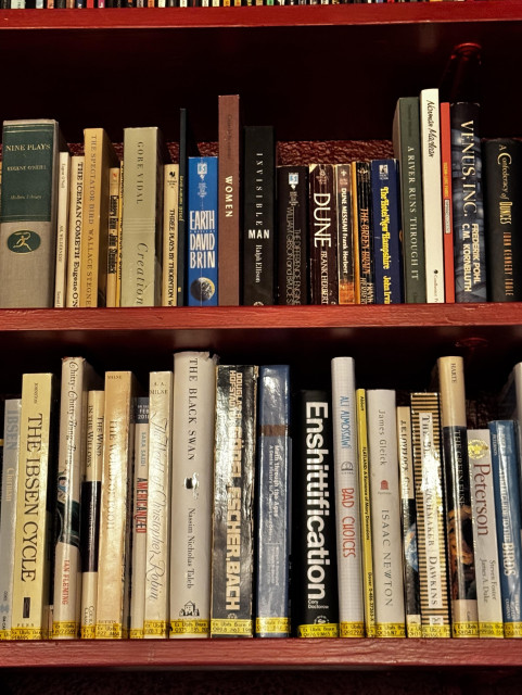 Bookshelf with Enshittification by Cory Doctorow. 