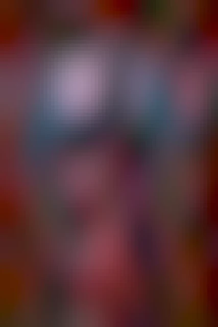 Romantasy book cover illustration: A dark, imposing castle with both Gothic and Ancient Greek elements, seen through a round frame of roses. Pink sand glitters around the roses and falls in the foreground. Among the roses we see a Spartan helmet, a shield, spears, and a small mouse.