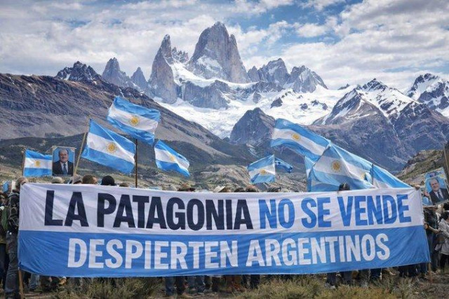 A giant blue and white banner reads PATAGONIA IS NOT FOR SALE, WAKE UP ARGENTINIANS