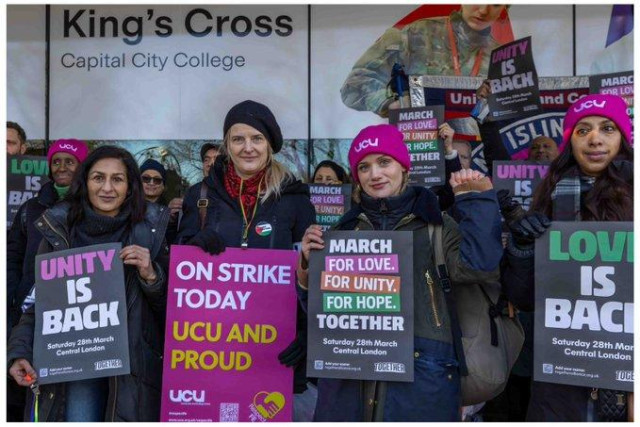 Union members from the UCU hold banners reading UNITY IS BACK, MARCH FOR LOVE, FOR UNITY, FOR HOPE on a picket line in King's Cross